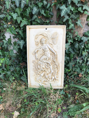 Nicely detailed plaque of a maiden holding fishing nets of her spoils